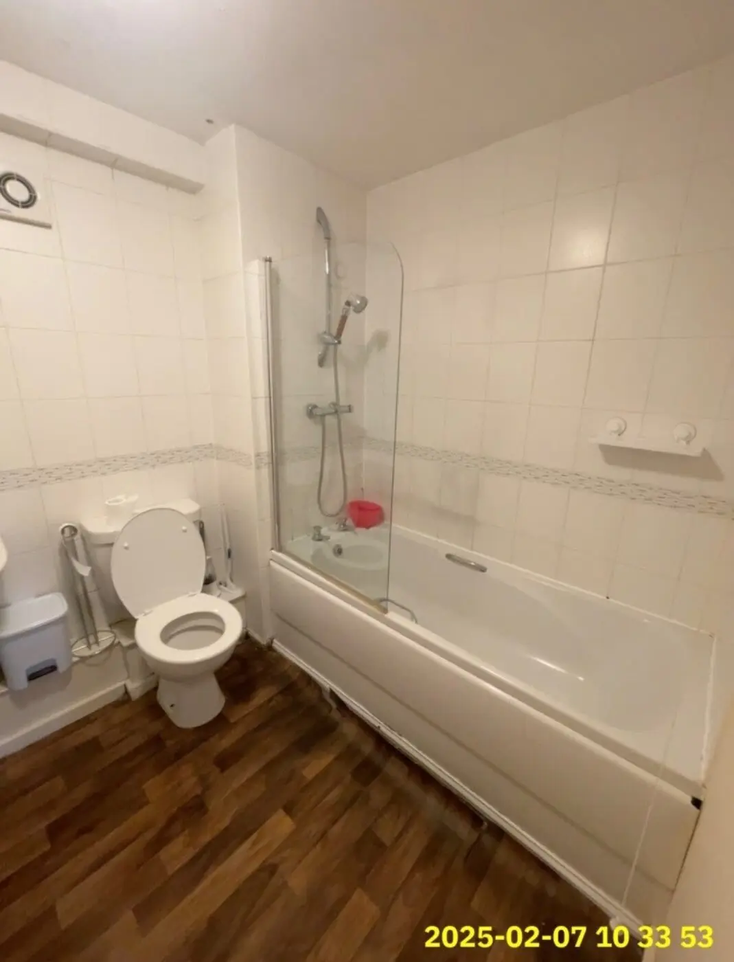 Bathroom before renovation with old bath and wall tiles