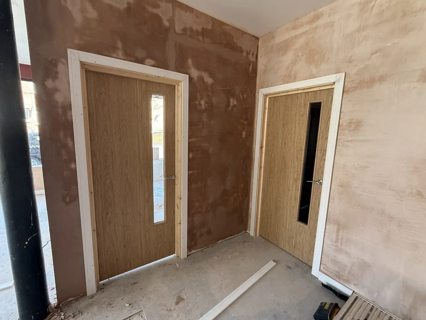 Freshly plastered entrance walls around two internal doors